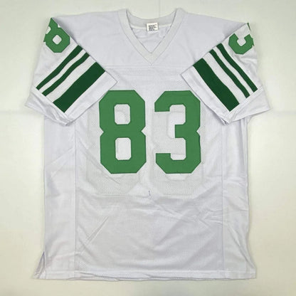 White football jersey with green number 83 and striped sleeves from professional sports league