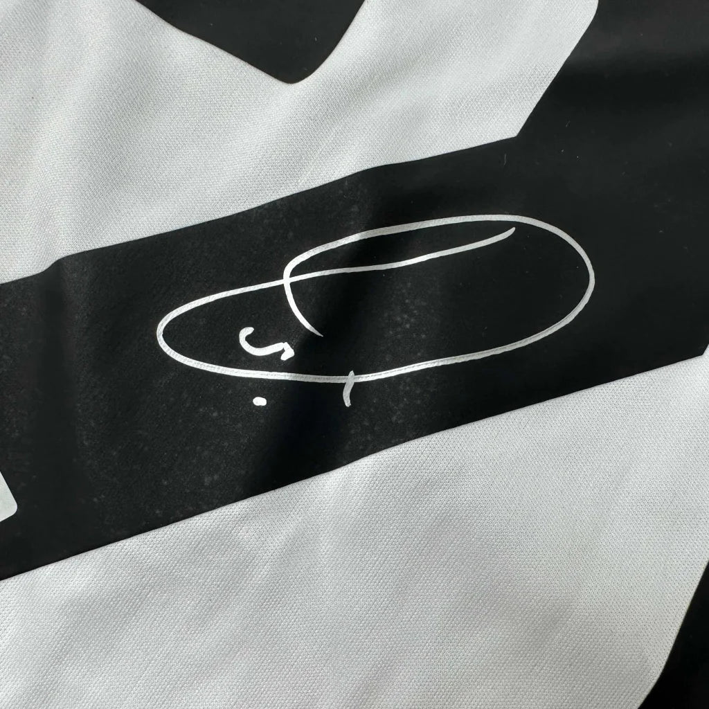Black and white striped Real Madrid jersey with signed Vini Vinicius Jr. hat design
