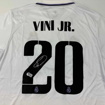 White Real Madrid jersey with VINI JR 20 and third party authentication for authenticity