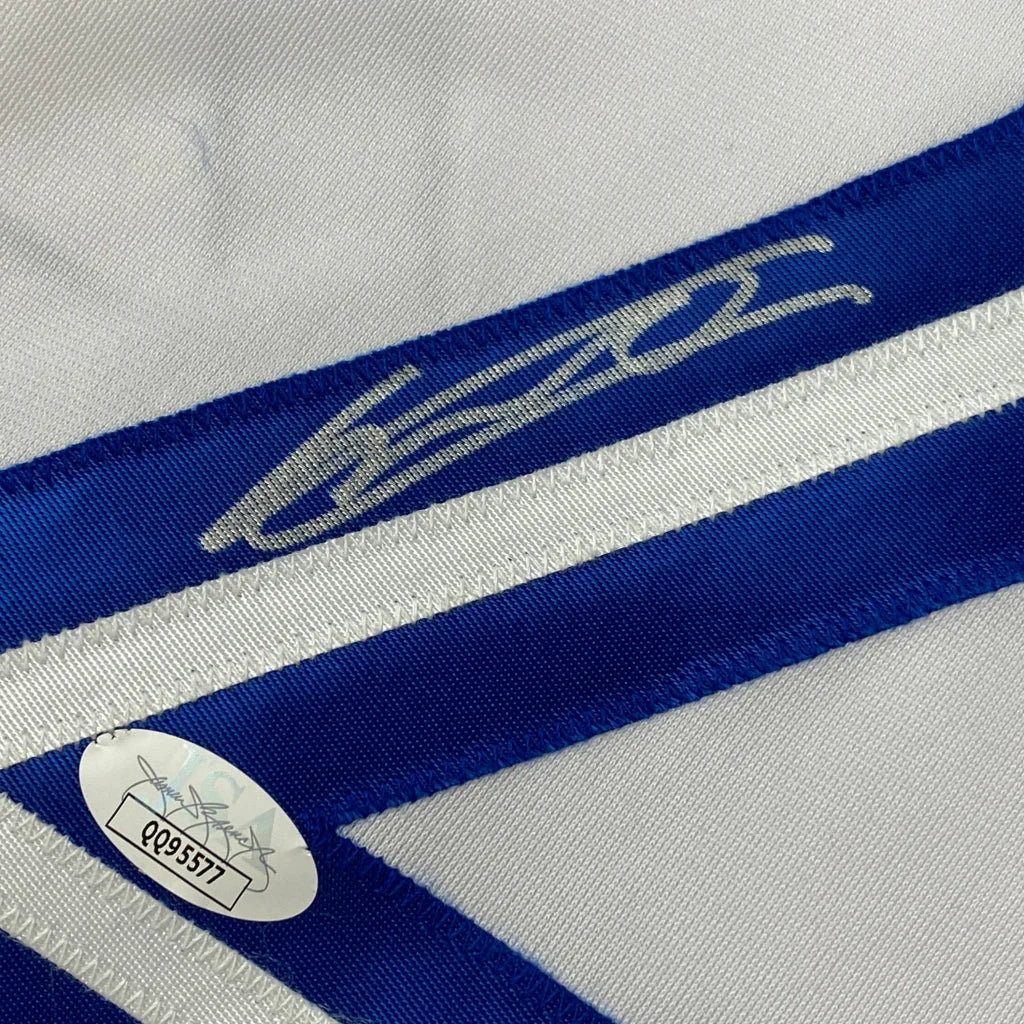 White and blue striped custom jersey with silver signature and authentication sticker