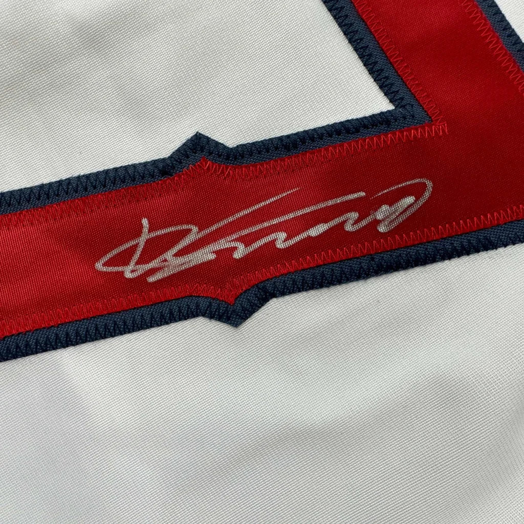 White fabric with red and blue embroidery and silver signature on custom jersey for sports league