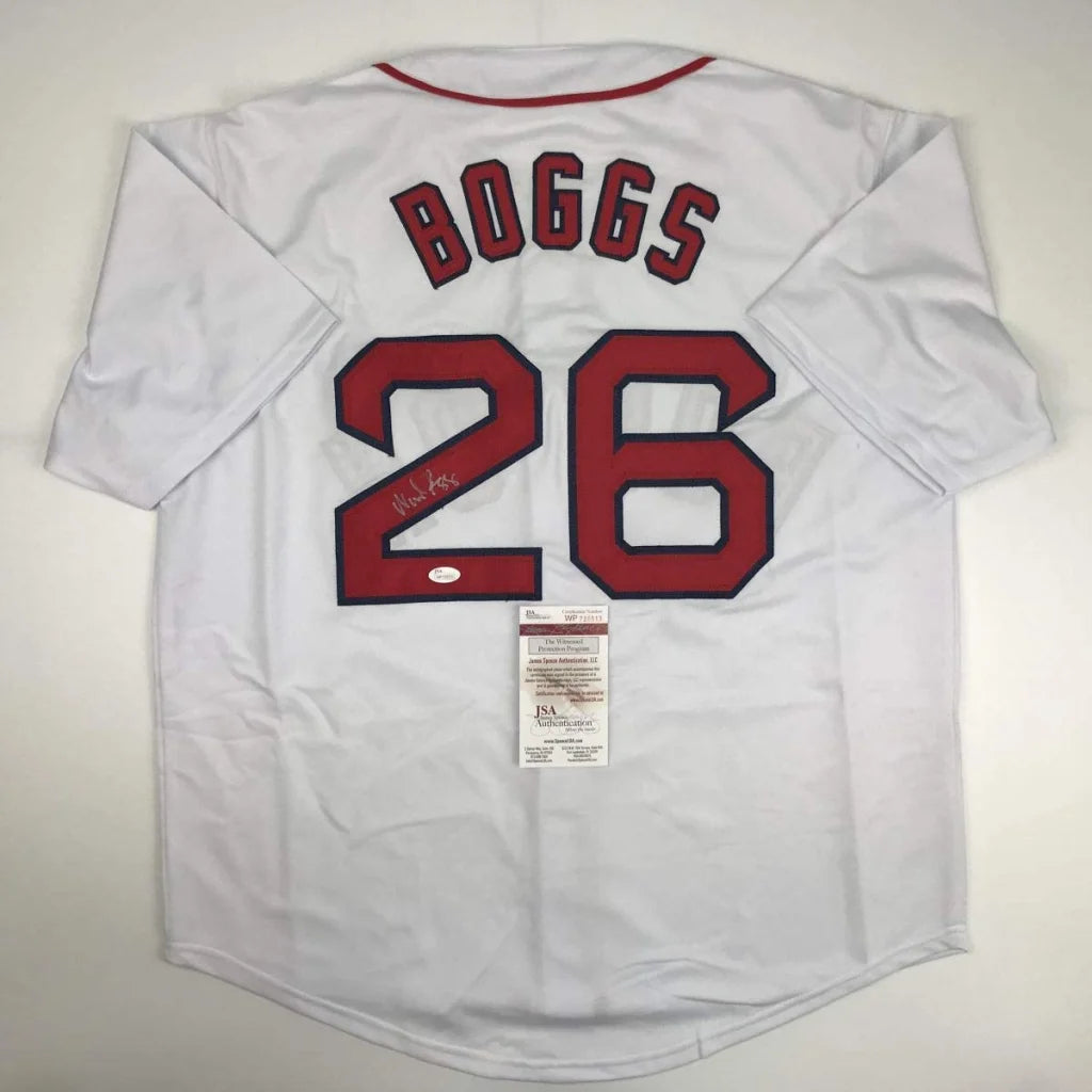 White Wade Boggs Boston jersey with autograph, red trim, and authentication sticker