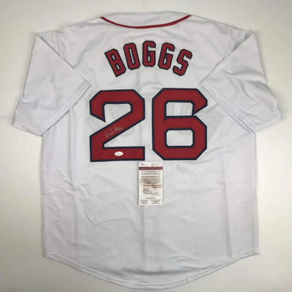 White Wade Boggs Boston jersey with autograph, red trim, and authentication sticker