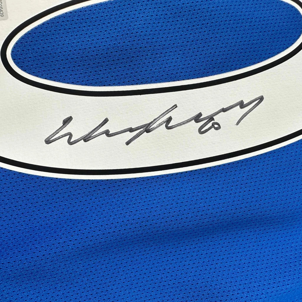 Blue sports jersey with white trim and black autograph, third party authentication included