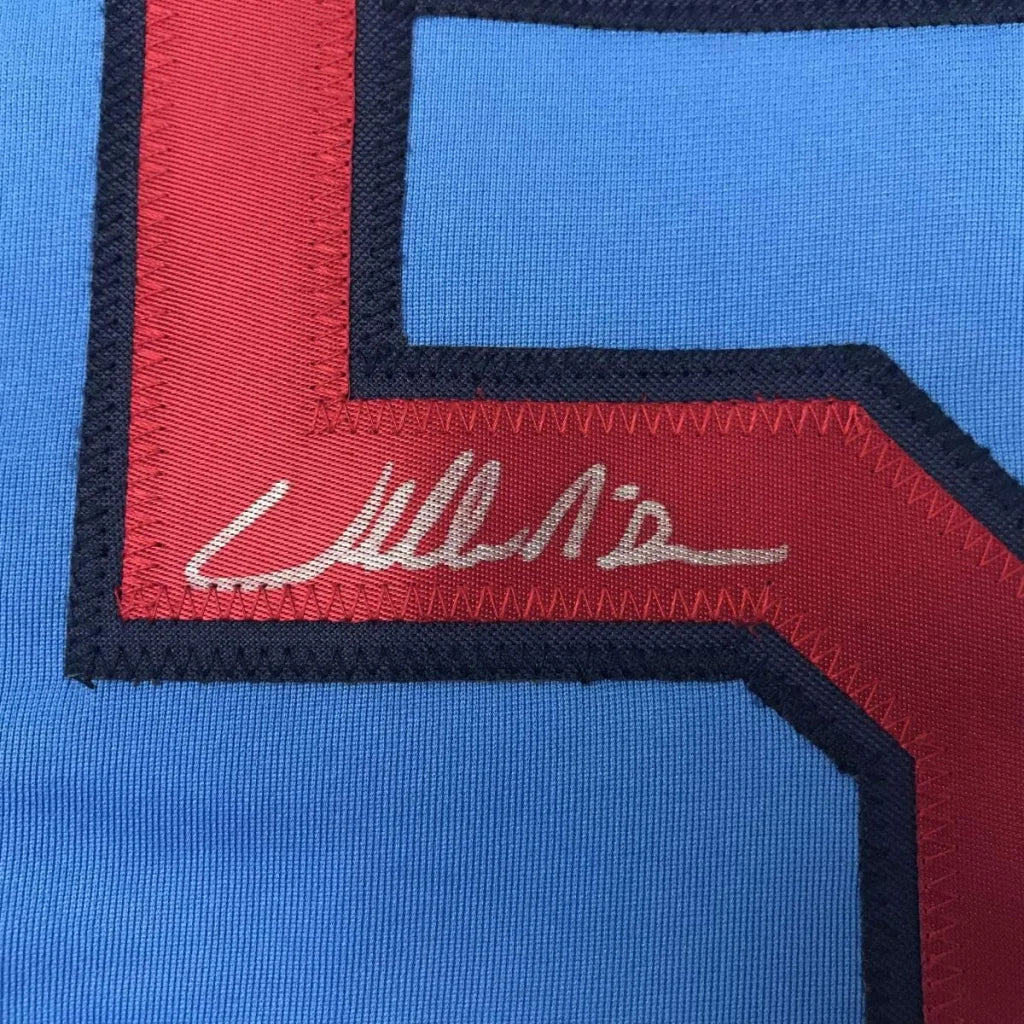 Light blue professional sports league jersey with red and dark blue number 5 and autograph