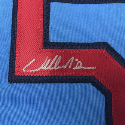 Light blue professional sports league jersey with red and dark blue number 5 and autograph