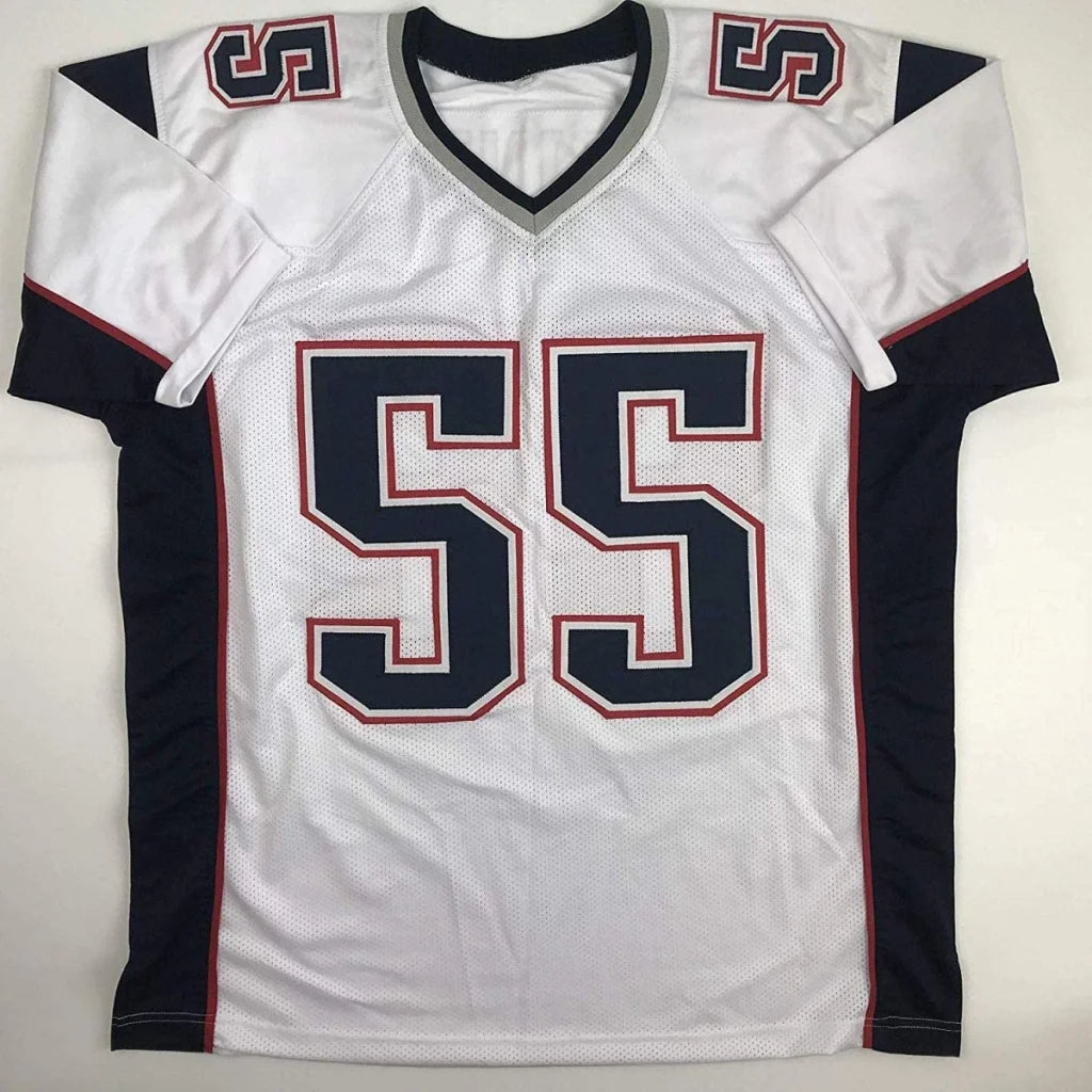 White football jersey with navy blue and red accents from Willie McGinest signed professional sports league jersey