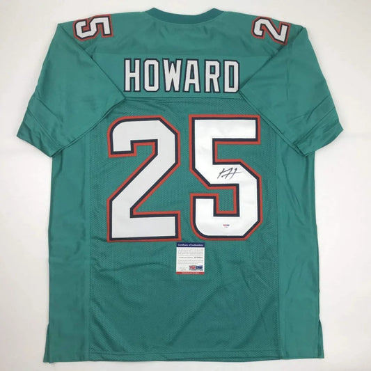 Back of a teal Miami dolphins custom jersey with orange white 25 and autographed name Howard from professional sports league