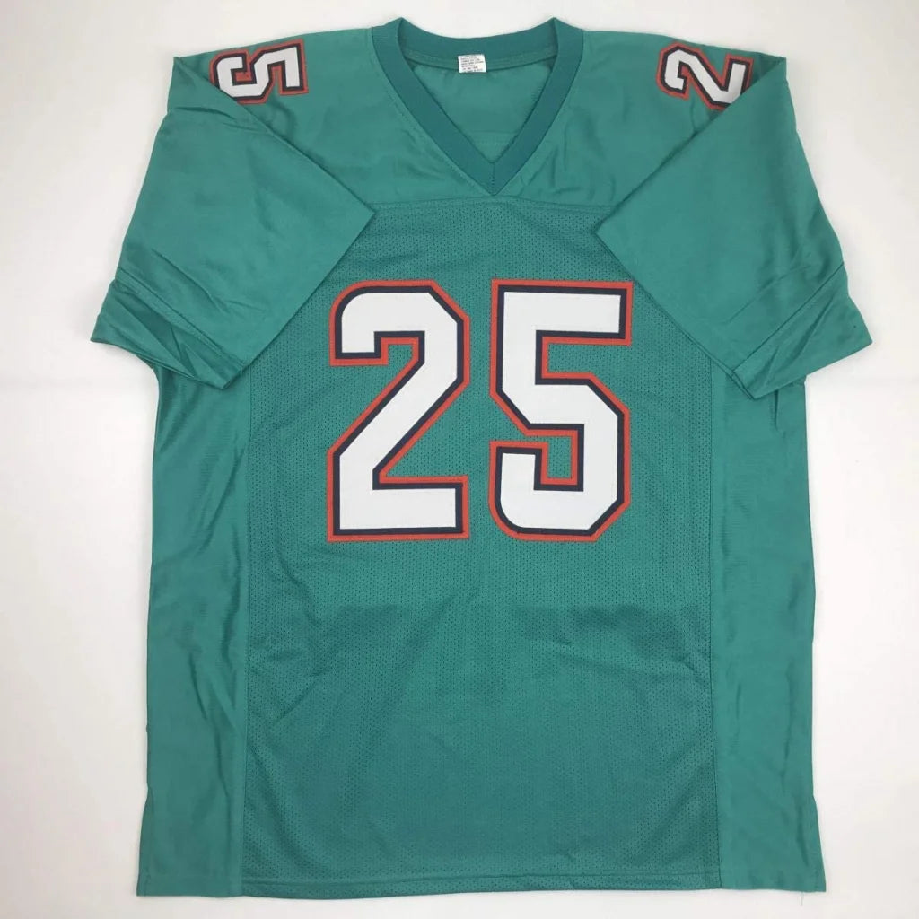 Autographed teal custom jersey featuring white and orange number 25 with shoulder patches from professional sports league