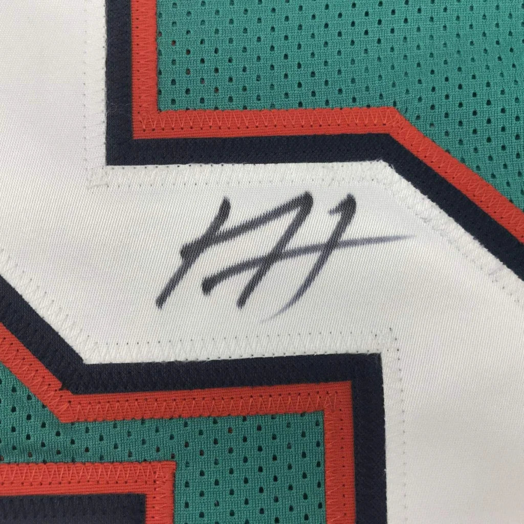 Autographed black ink signature on a white mesh miami teal custom jersey with teal and orange trim for professional sports league