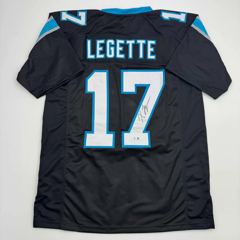 Back side of a black carolina panthers custom jersey featuring autographed legette 17 in light blue and white lettering professional sports league