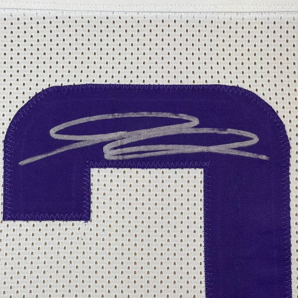 White football jersey with purple number and silver autograph ready to hang