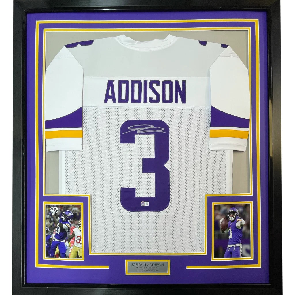Autographed white football jersey with purple accents and player photos for hanging