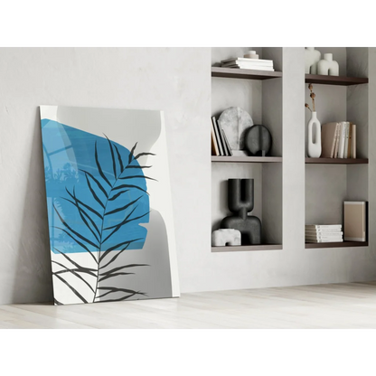 Bold blue palm frond glass wall art with black silhouette on white background