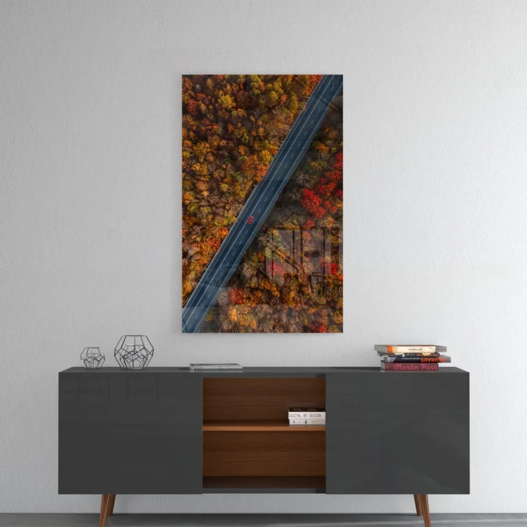 Autumn forest road aerial view glass wall art in vibrant reds