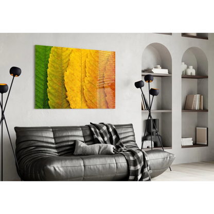 Vibrant autumn leaves glass wall art in green, yellow, orange hues