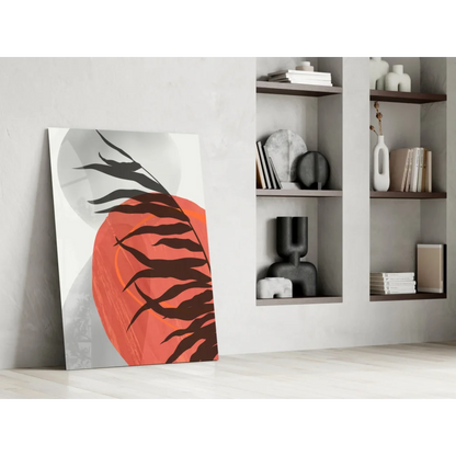 Bold black leaf silhouettes on vibrant orange glass wall art with gray gradients