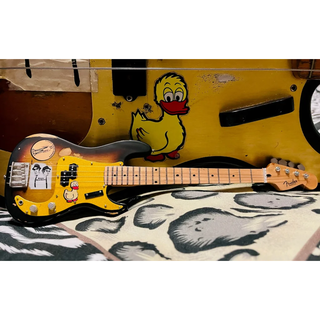 Axe Heaven Fender mini Stratocaster with sunburst finish and adjustable A-frame stand