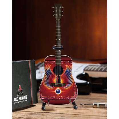 Axe Heaven Journey Phoenix Wings mini guitar with vibrant red orange wings on adjustable A-frame stand