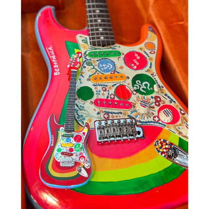 Axe Heaven mini guitar Rocky Strat in 1960s psychedelic rainbow hues with adjustable A-frame stand