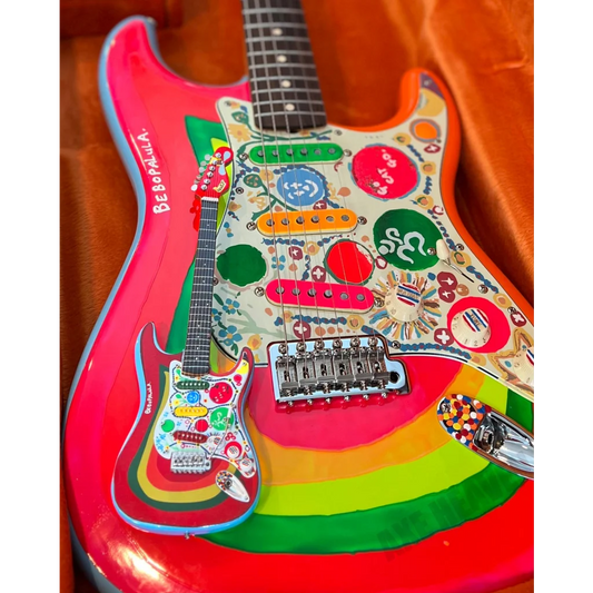 Axe Heaven mini guitar Rocky Strat in 1960s psychedelic rainbow hues with adjustable A-frame stand