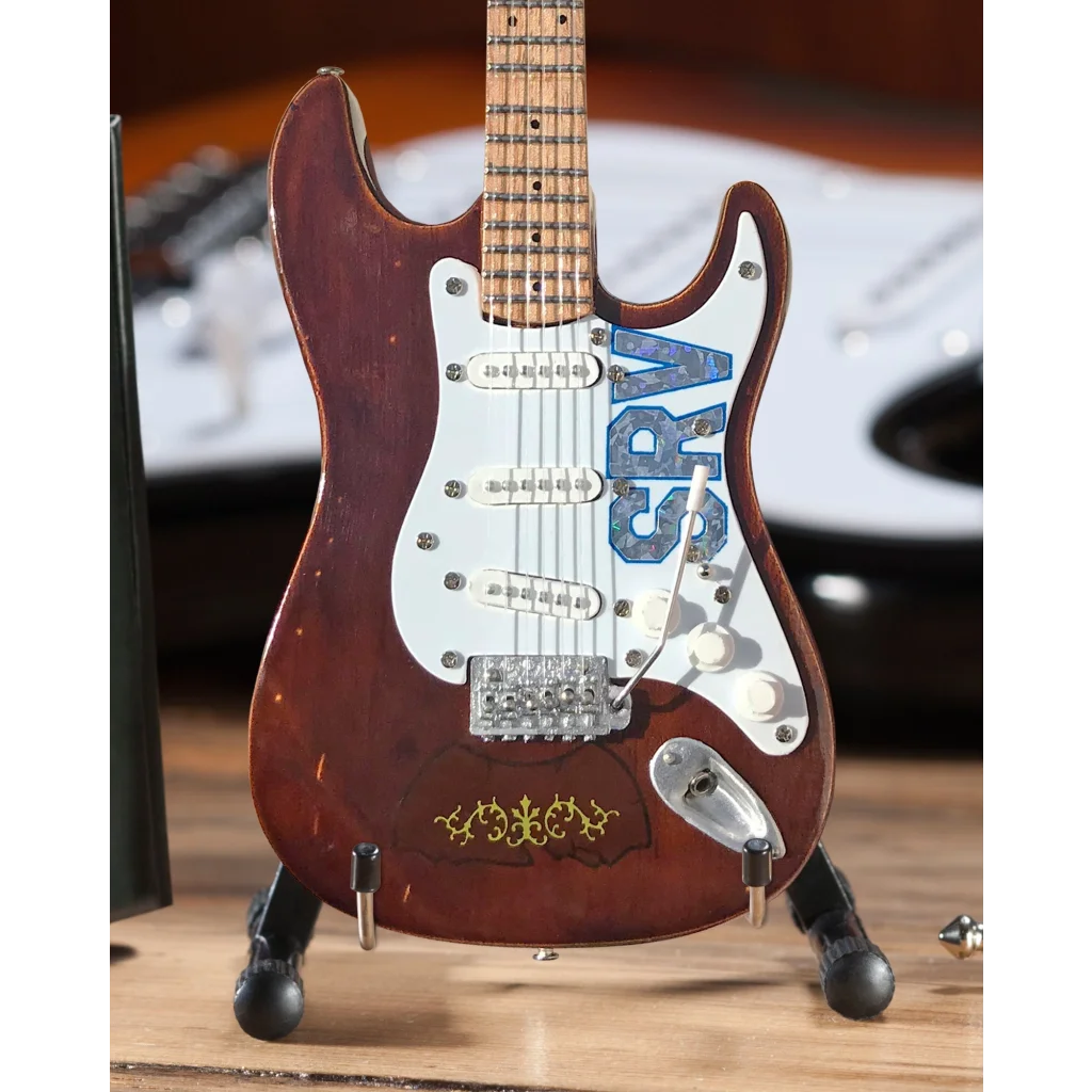 Axe Heaven mini guitar SRV Lenny replica in red with gold accents and ABS logo on adjustable A-frame stand