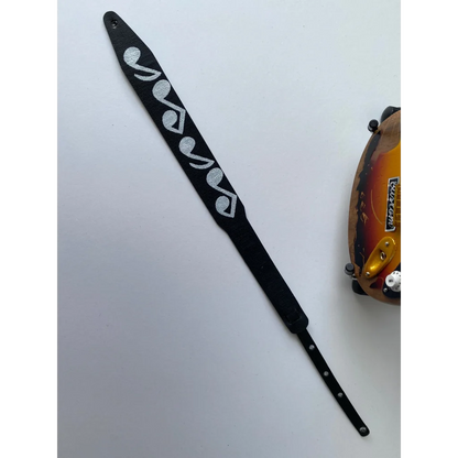 Axe Heaven mini guitar strap with black and white leather heart pick holder