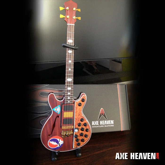 Axe Heaven Miniature Grateful Dead guitar with red brown grain, black pickguard, yellow pegs, adjustable A-frame stand