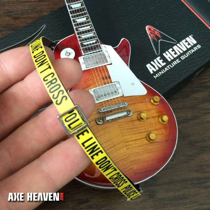 Axe Heaven police line mini guitar with sunburst design and tape strap