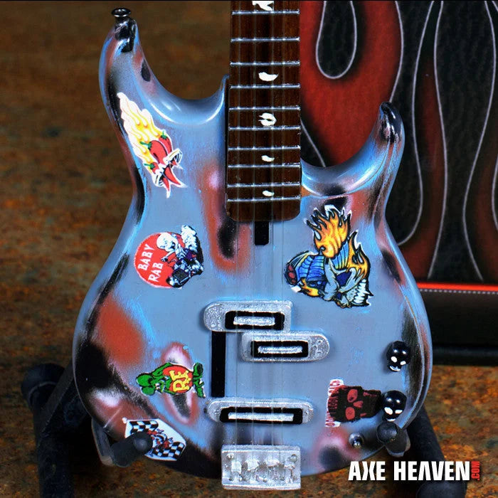 Axe Heaven Rat Rod mini silver guitar with stickers, glossy finish, and adjustable A-frame stand