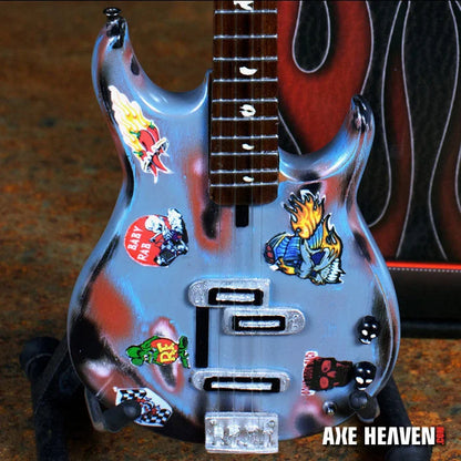 Axe Heaven Rat Rod mini silver guitar with stickers, glossy finish, and adjustable A-frame stand