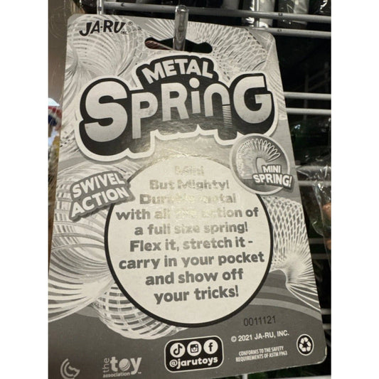 Front of white blister packaging for Jaru Mini Metal Spring toy showing product name, swivel action badge, and descriptive text on cardboard backing.