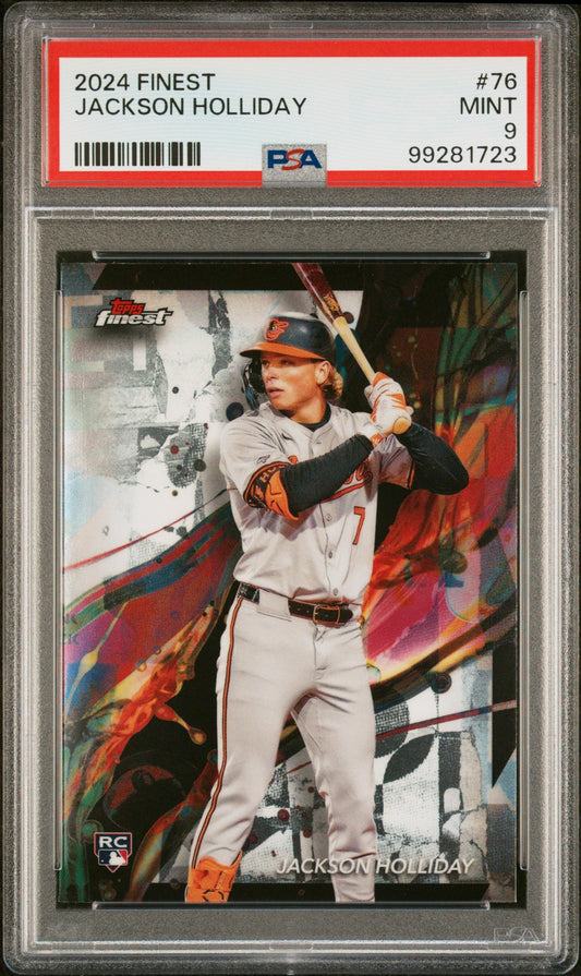 PSA-graded rookie card in clear plastic holder showing Jackson Holliday in Orioles uniform with bat, colorful background design, red label with card details visible.