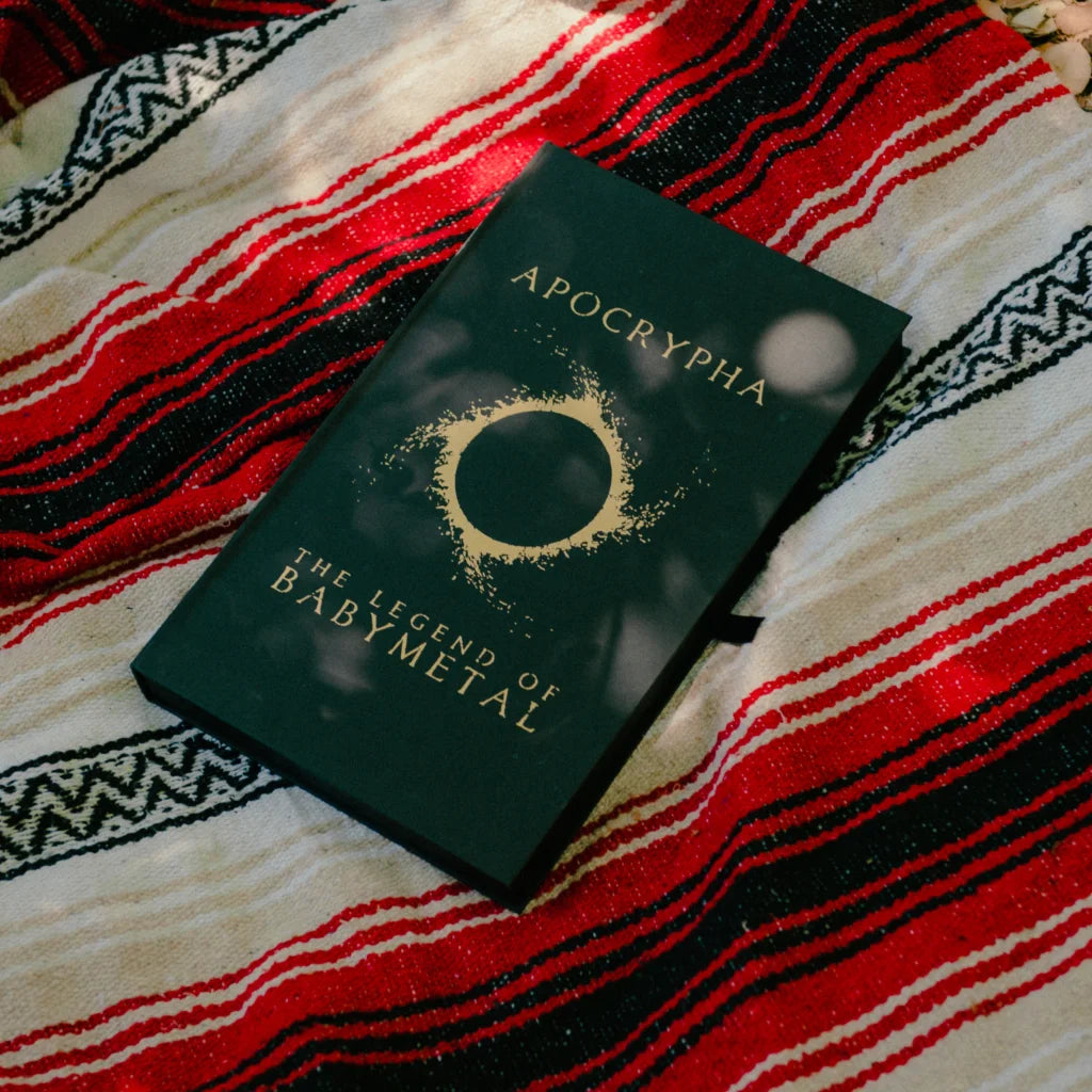 Dark green hardcover babymetal deluxe edition book with gold foil lettering and circular design by gmb chomichuk 9x15