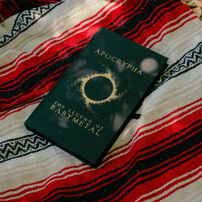 Dark green hardcover babymetal deluxe edition book with gold foil lettering and circular design by gmb chomichuk 9x15