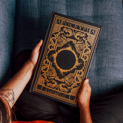 Black hardcover babymetal deluxe edition book apocrypha with intricate gold foil detailing by gmb chomichuk 9x15
