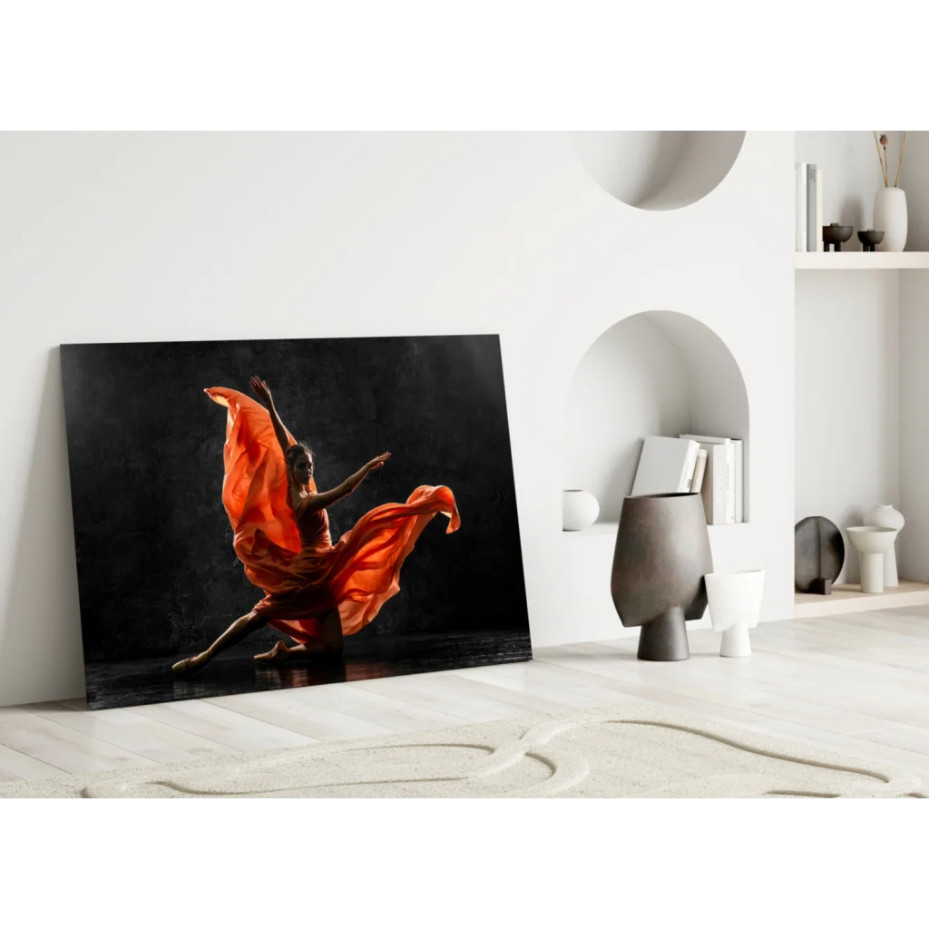 Vibrant orange dancer glass wall art leaning on white wall