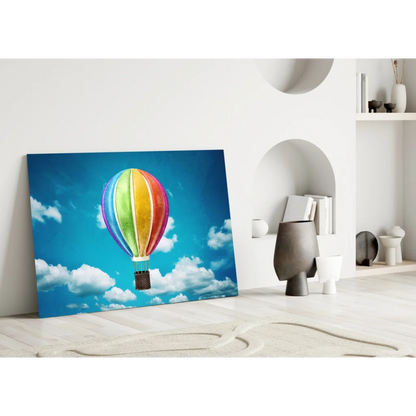 Vibrant rainbow hot air balloon wall art canvas print on blue sky