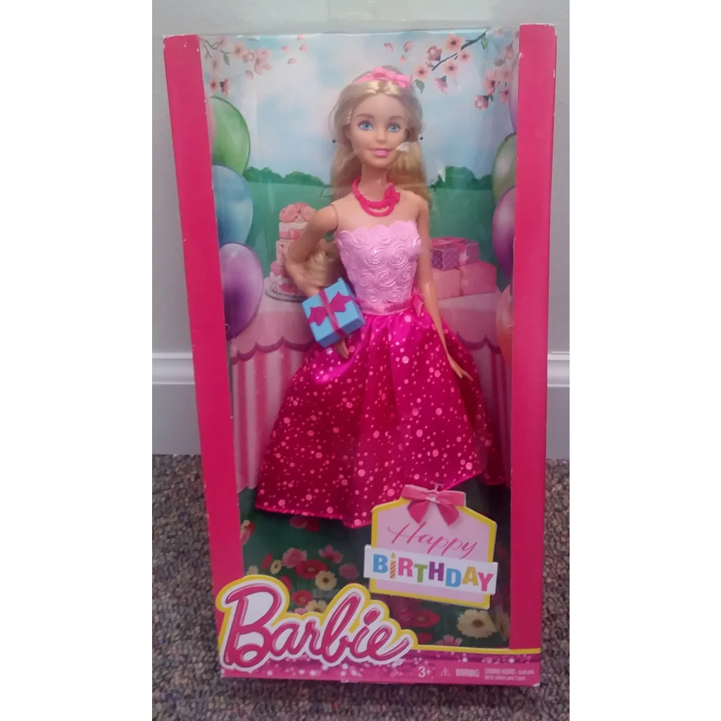 Happy Birthday Barbie doll in pink polka dot dress holding gifts