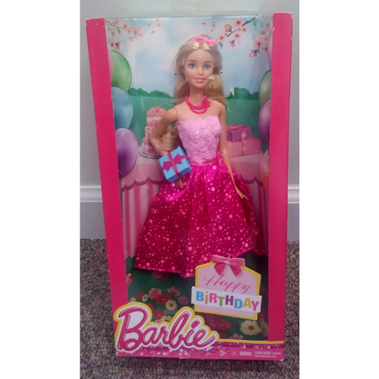Happy Birthday Barbie doll in pink polka dot dress holding gifts