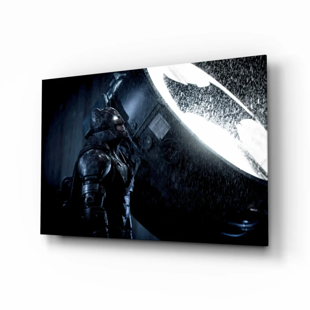 Dark metallic Batman in armored suit before glowing white bat-symbol on epic glass wall art