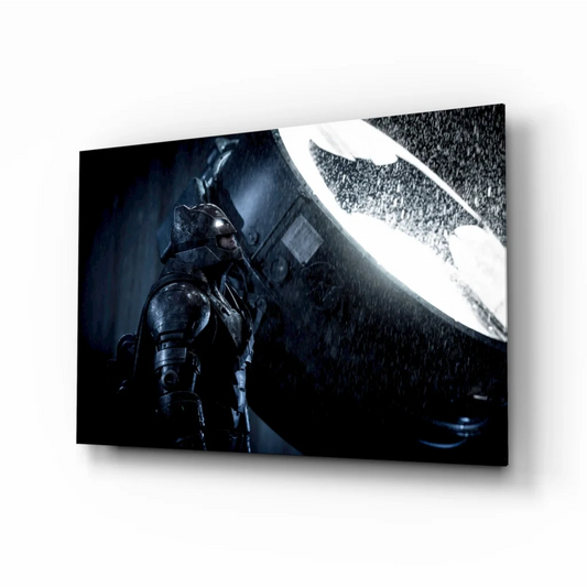Dark metallic Batman in armored suit before glowing white bat-symbol on epic glass wall art