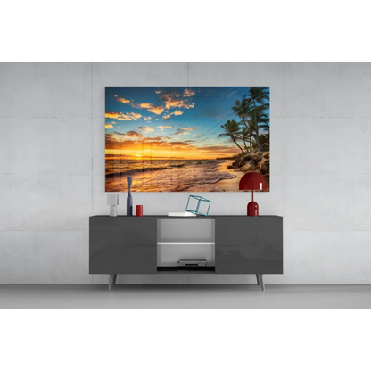 Vibrant tropical beach sunset glass wall art with golden hues and palm silhouettes