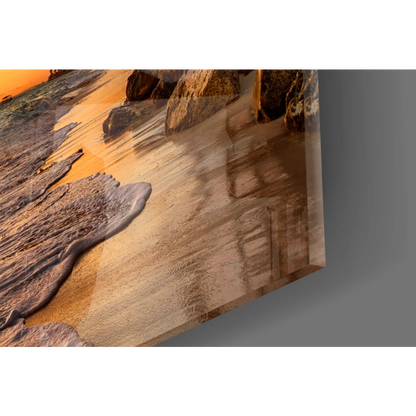 Tropical beach sunset glass wall art with serene waves and orange sky
