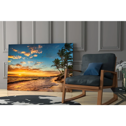 Tropical beach sunset glass wall art canvas print with vibrant orange and blue hues, palm trees, and ocean waves