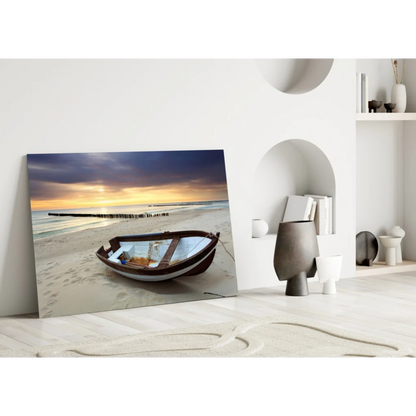 Weathered rowboat on beach under sunset sky in glass wall art print