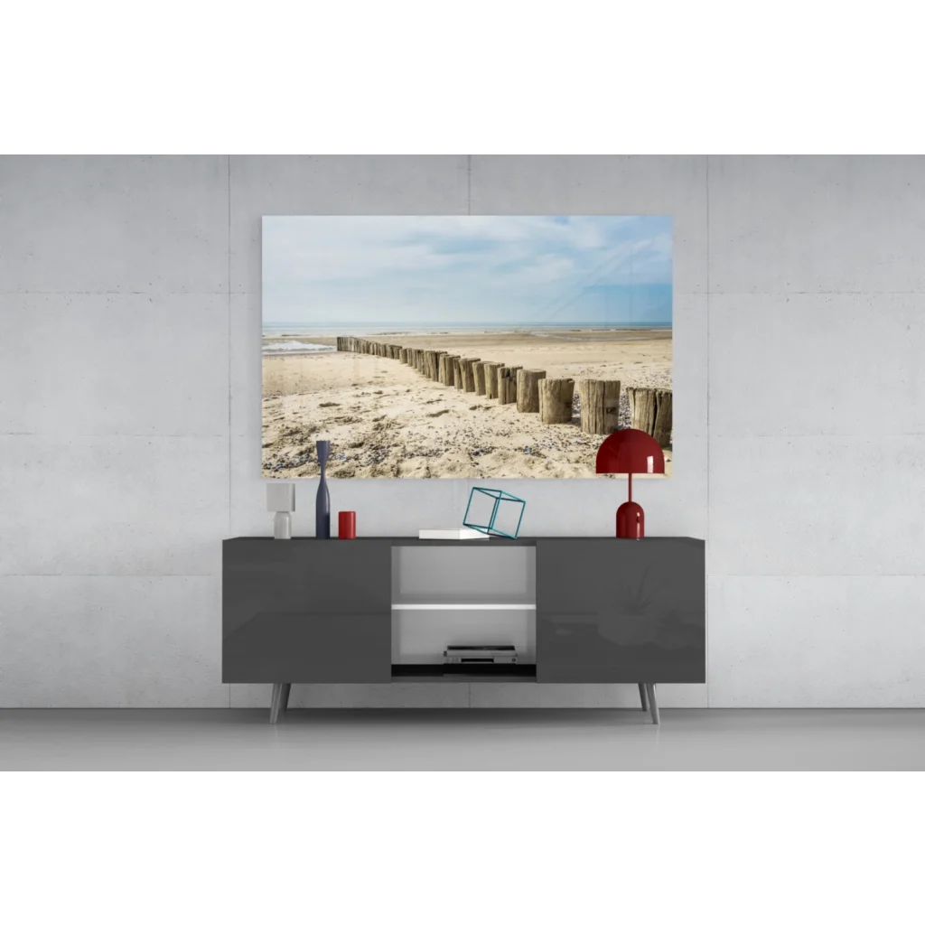 Modern gray console table with sleek legs under Coastal Wooden Posts glass wall art