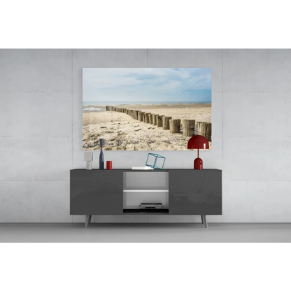 Modern gray console table with sleek legs under Coastal Wooden Posts glass wall art