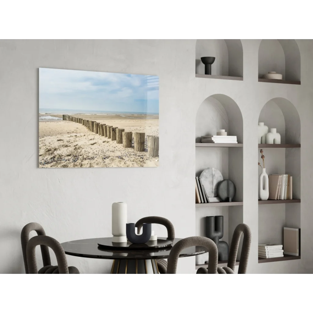 Beige and blue coastal glass wall art of wooden posts on sandy beach
