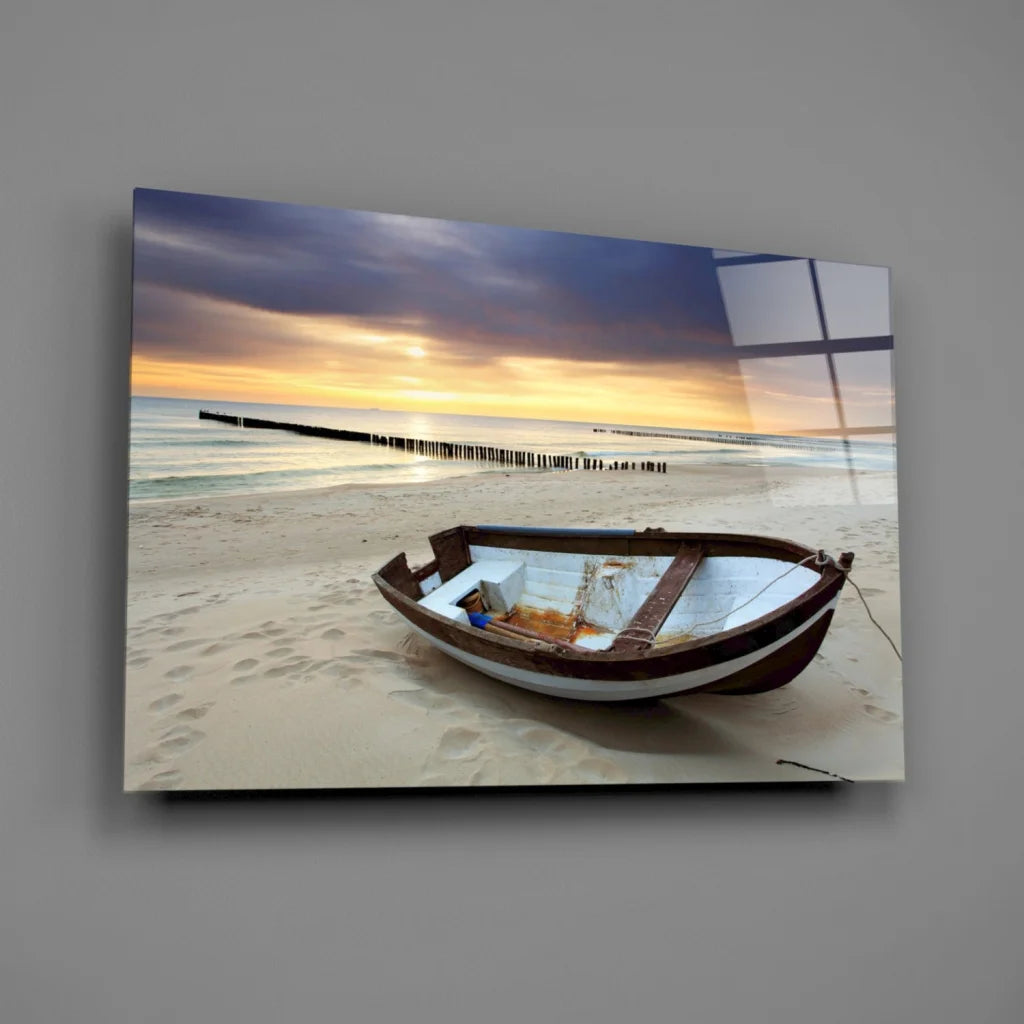 Weathered rowboat on beach at sunset glass wall art print